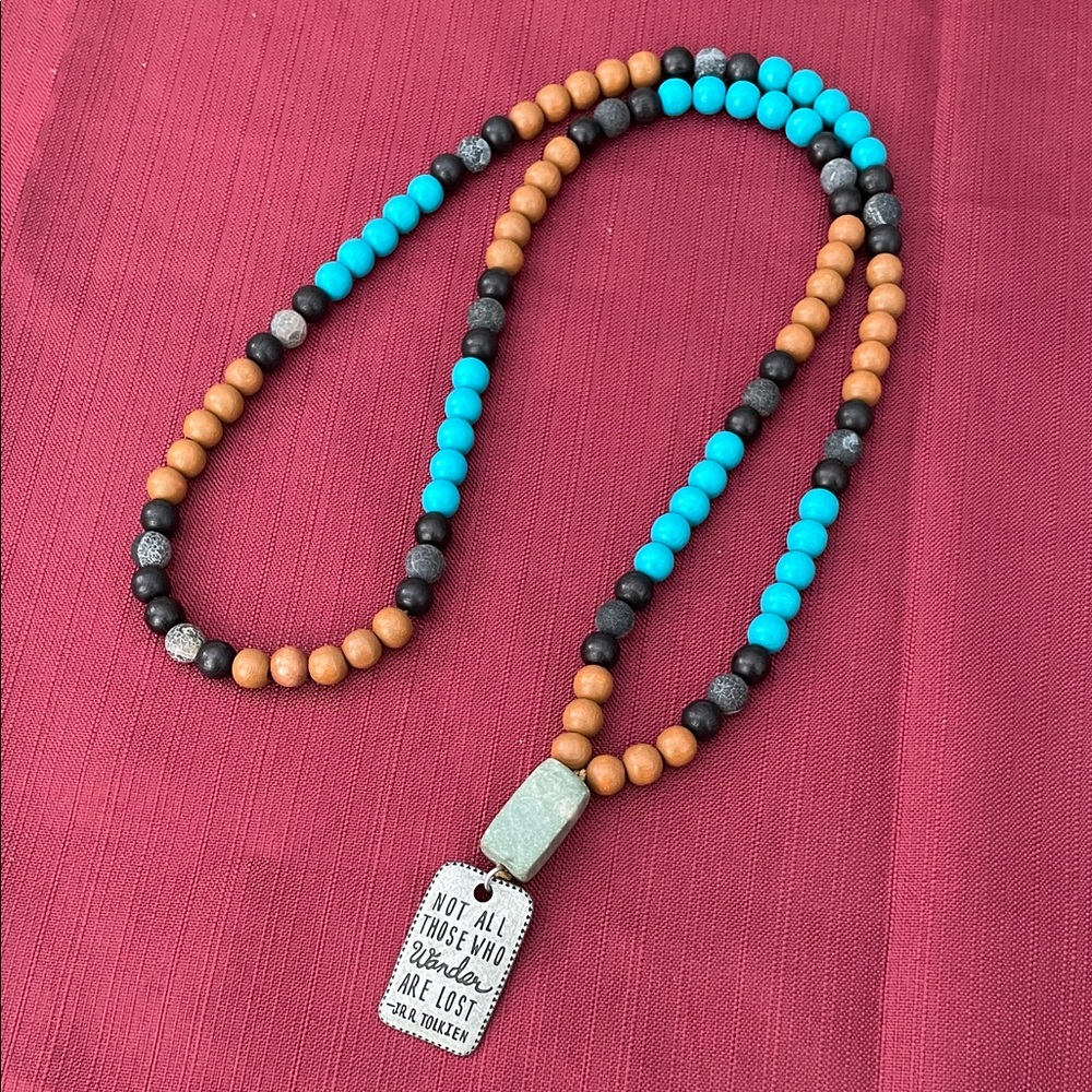 Hand assembled beaded necklace metal pendant wander